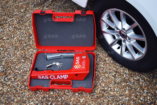 Clamp and keys shown in case next to wheel